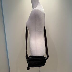 Black Kipling crossbody bag with magnetic flap closure